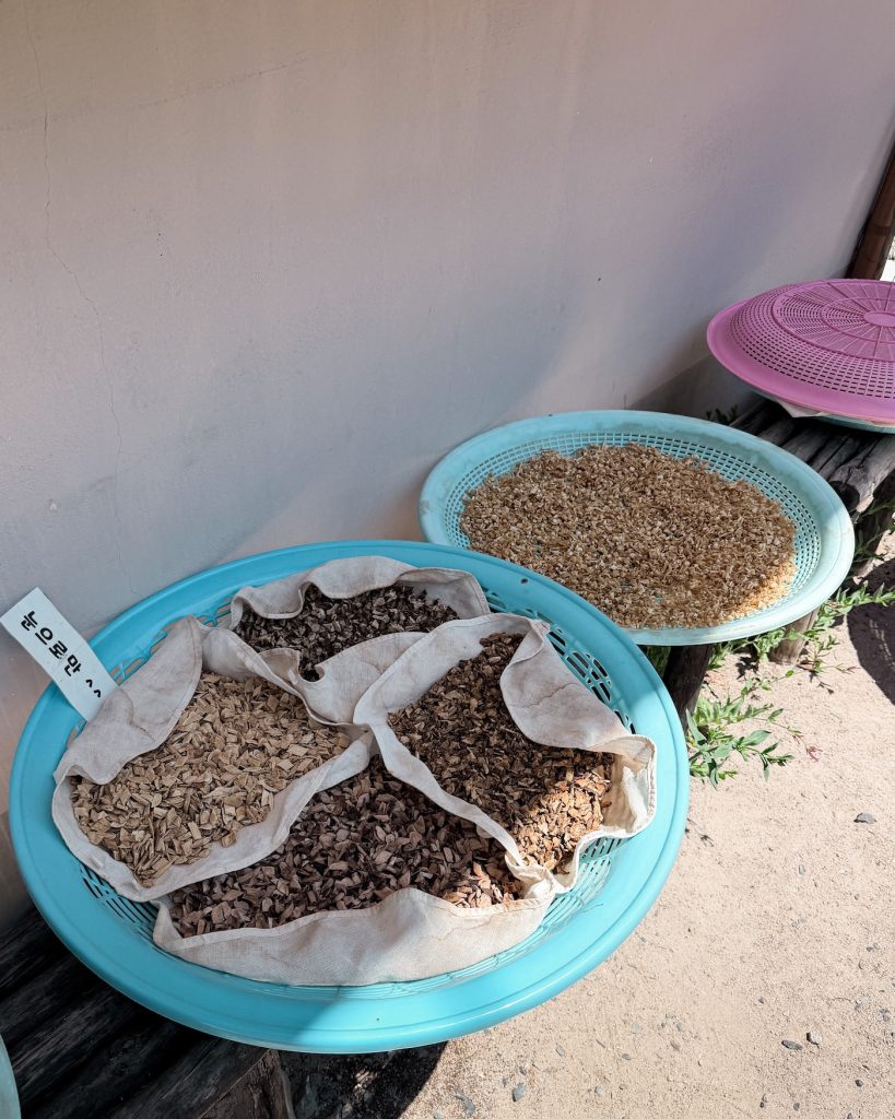 Baskets of dried herbs and grains drying outside a traditional tea house in Gyeongju before being brewed into Korean herbal tea.