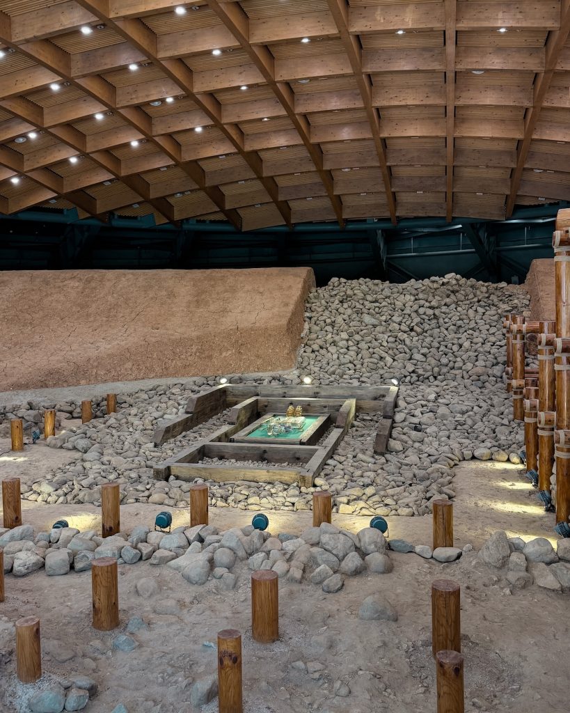 Full-scale cross-sectional reconstruction of a Silla royal tomb inside Geumgwanchong, showing layers of stones, burial chambers, and excavation areas. The exhibit helps visitors understand how ancient Korean royal tombs were built.